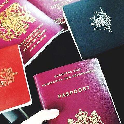 Cropped Image Of Friends Holding Passports