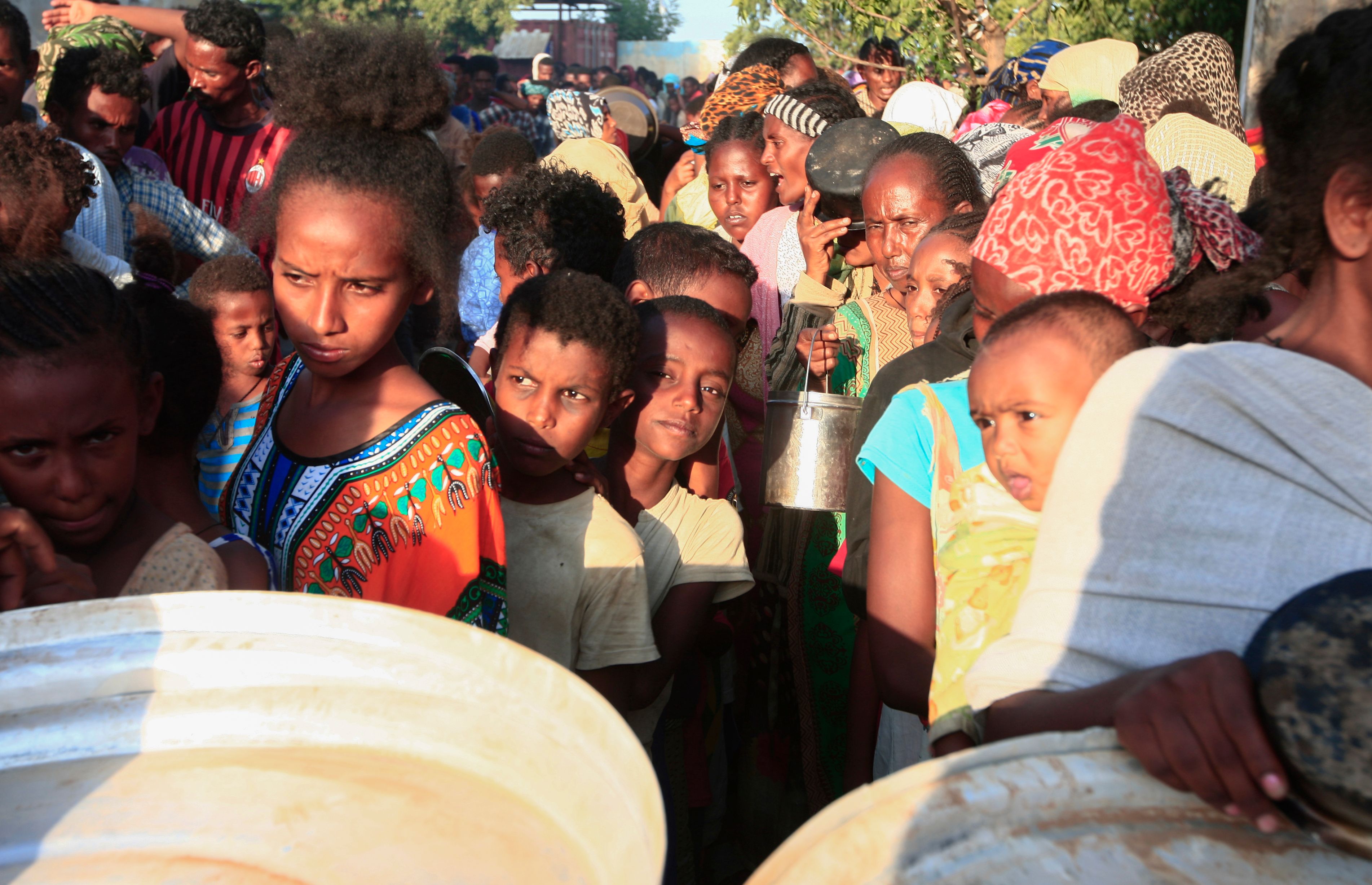 Ethiopian refugees who fled intense fighting in Tigray wait for their ration of food in the border reception centre of Kassala in Sudan, on 14 November, 2020.