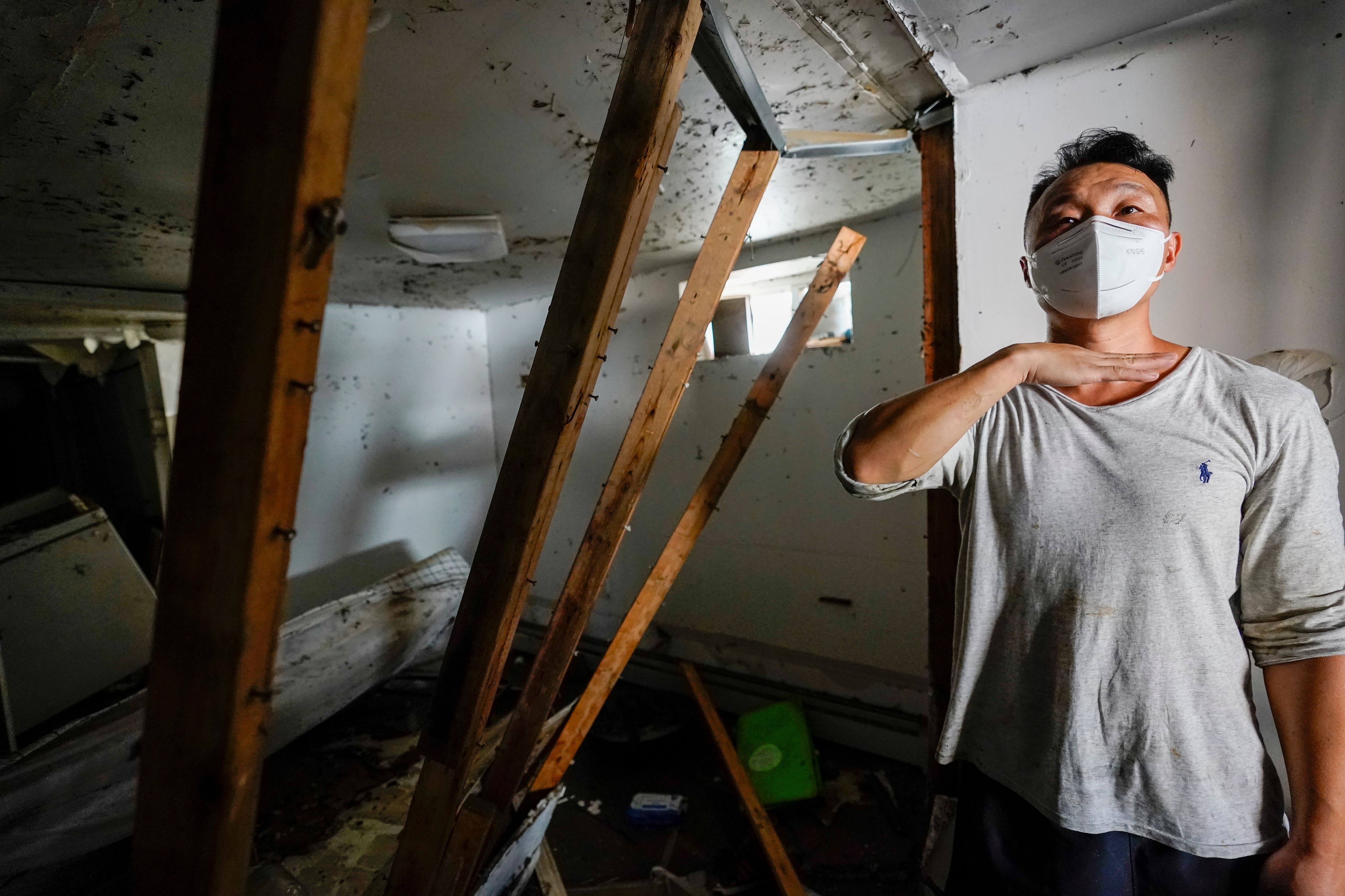 Danny Hong shows where the water reached up to him in his apartment in New York, Sept. 2, 2021, in New York. .(AP Photo/Mary Altaffer)