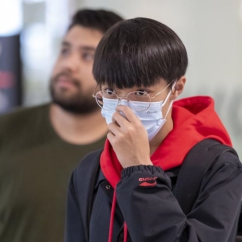 Man wears a protective mask at Brisbane International Airport.