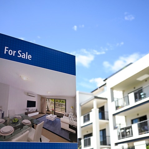 A real estate advertising board is seen next to a house in Canberra, Friday, March 1, 2019. (AAP Image/Lukas Coch) NO ARCHIVING