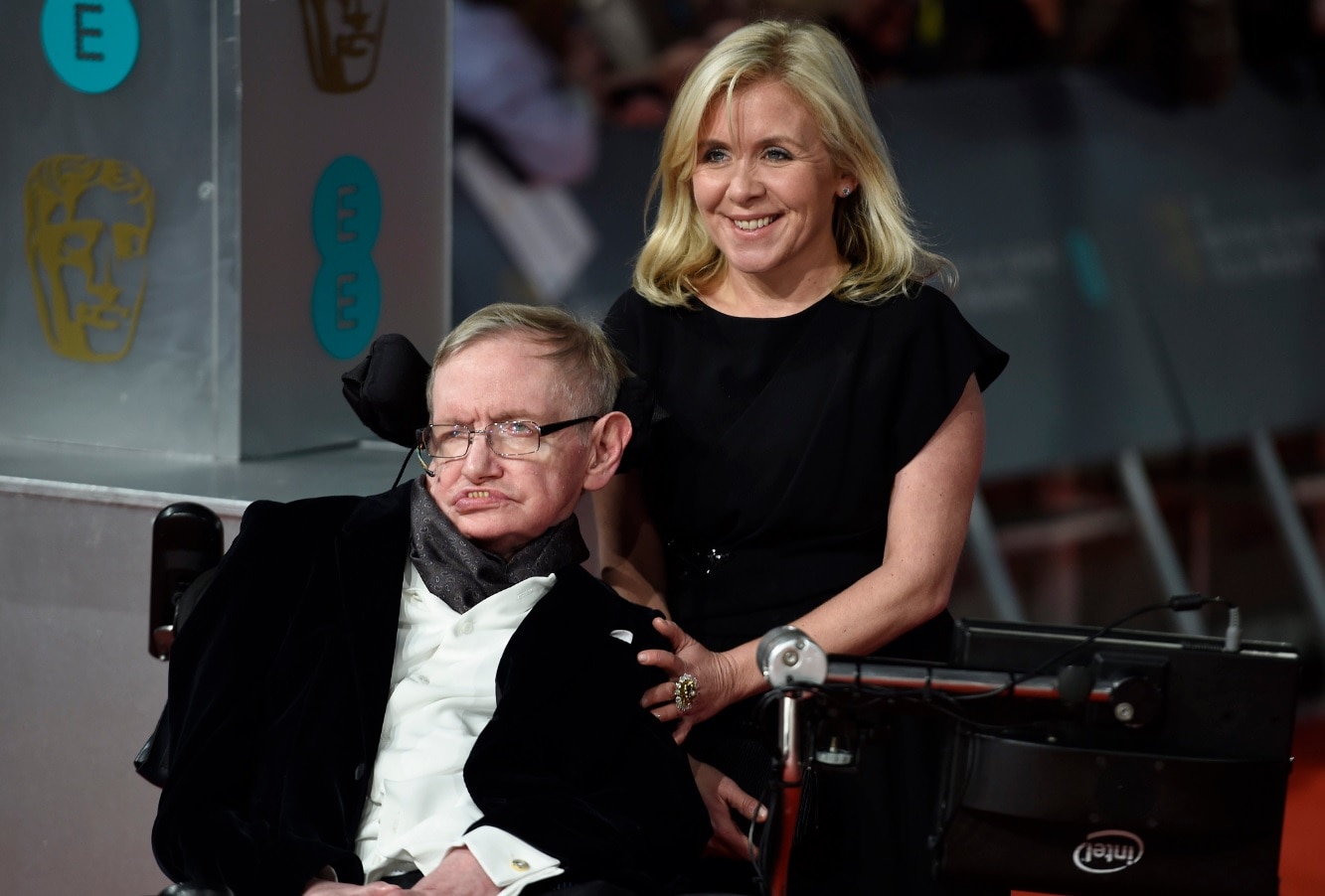 British scientist Stephen Hawking (L) and his daughter Lucy Hawking (R) arrive on the red carpet for the 2015 British Academy Film Awards 