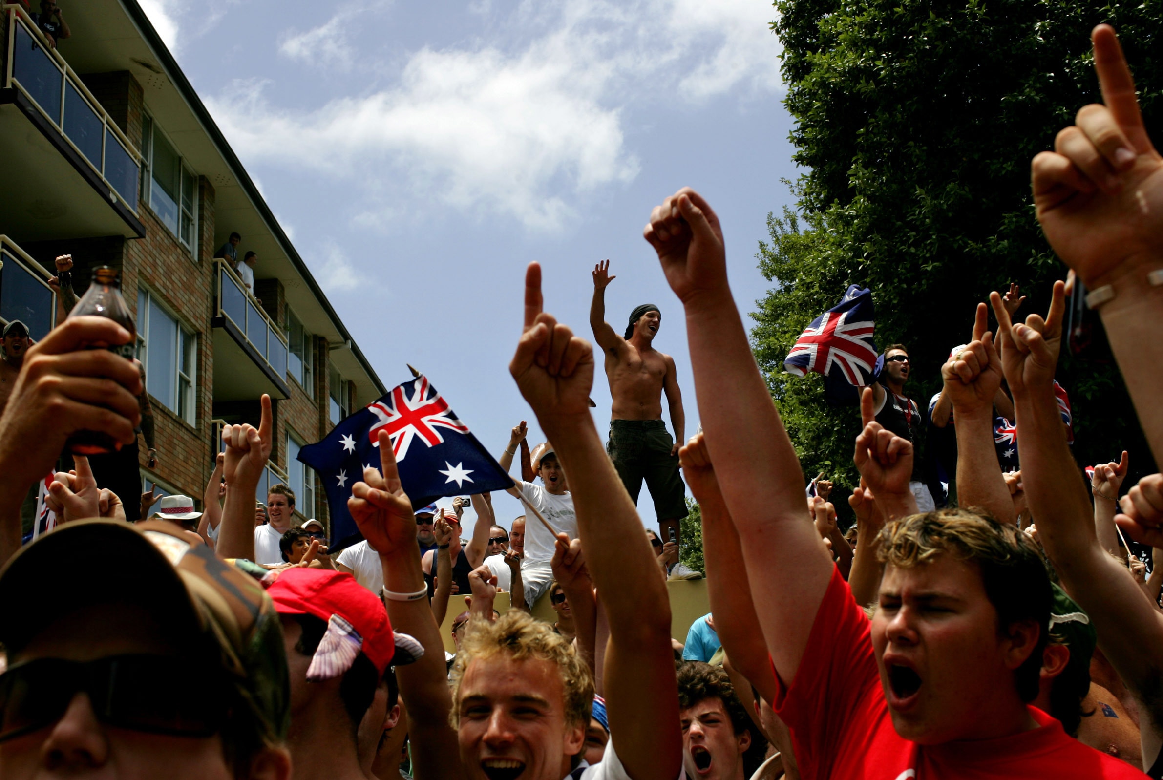 A crowd gathers outside 'Northies Hotel' at Cronulla after a man was chased inside during the riots.