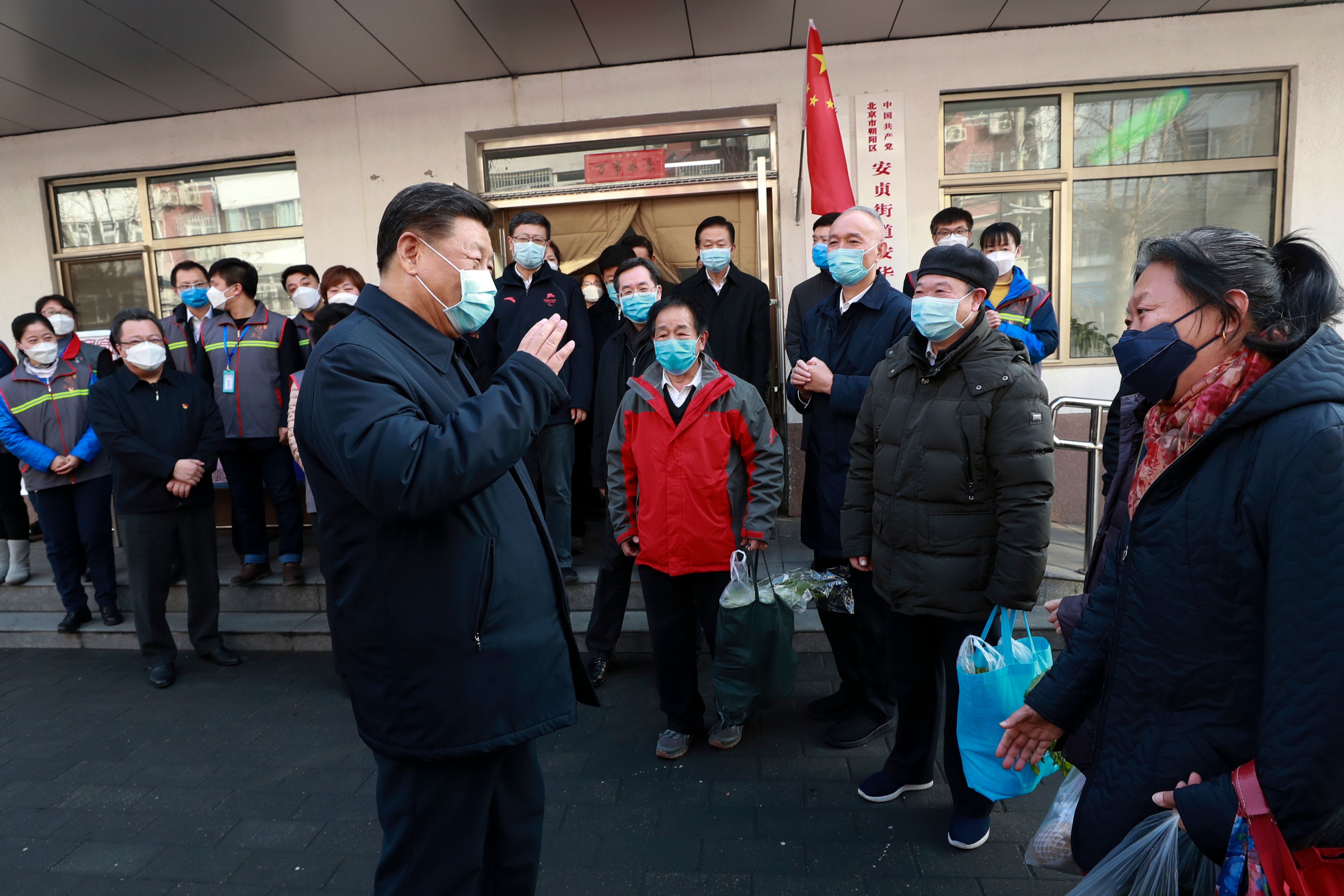 Chinese President Xi Jinping speaks to residents as he inspects the coronavirus pneumonia prevention and control work in Beijing.