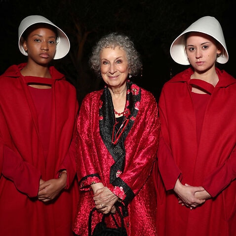 'The Handmaid's Tale' author Margaret Atwood poses with two 'handmaids' at Hulu's 2017 Emmy After Party on September 17.