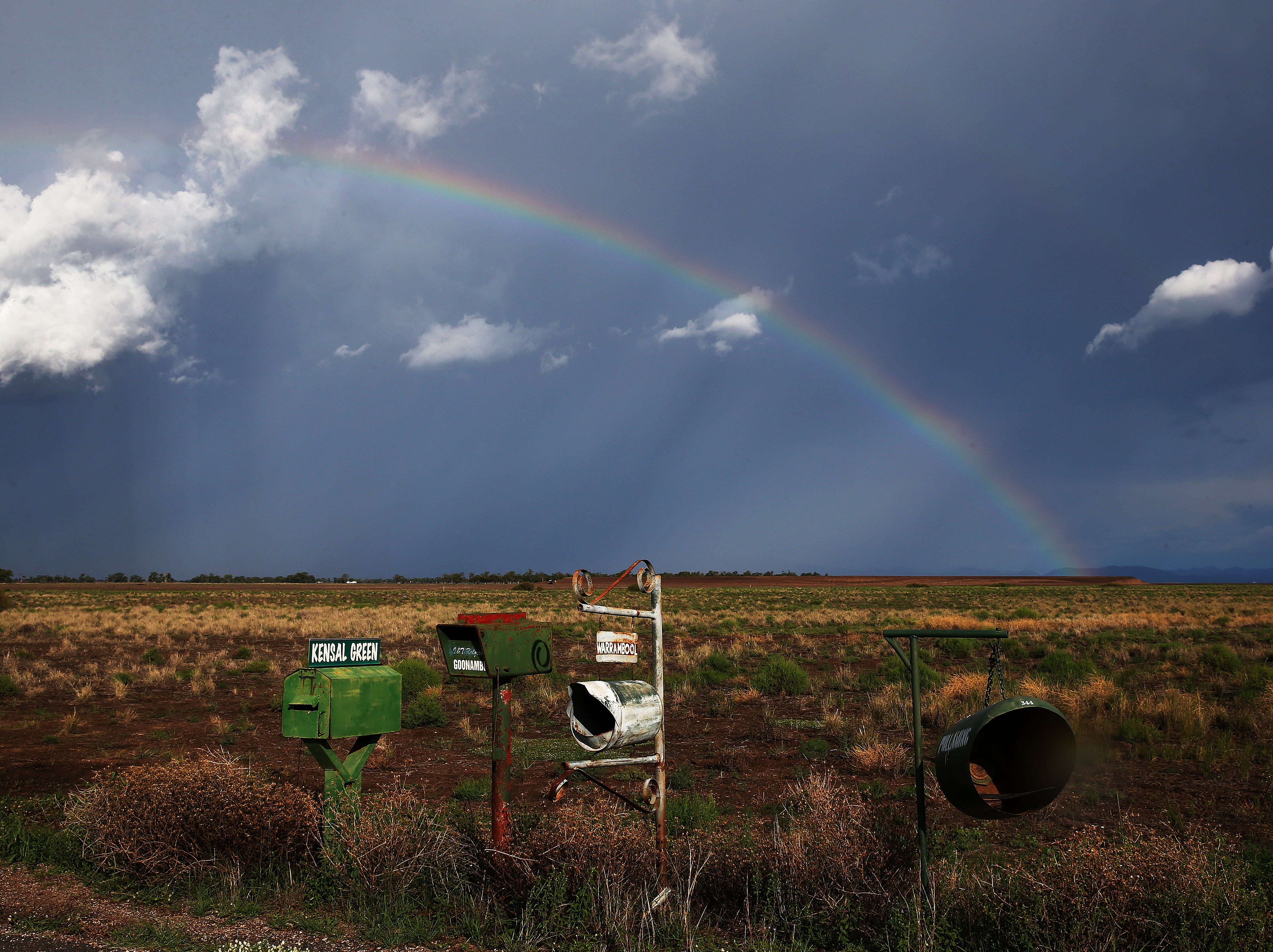 A rainbow appears behind a storm front on the Breeza Plains in north west NSW. Residents in parts of NSW continue to face floodwater risks after a weekend of torrential downfalls. (AAP Image/ Peter Lorimer) NO ARCHIVING