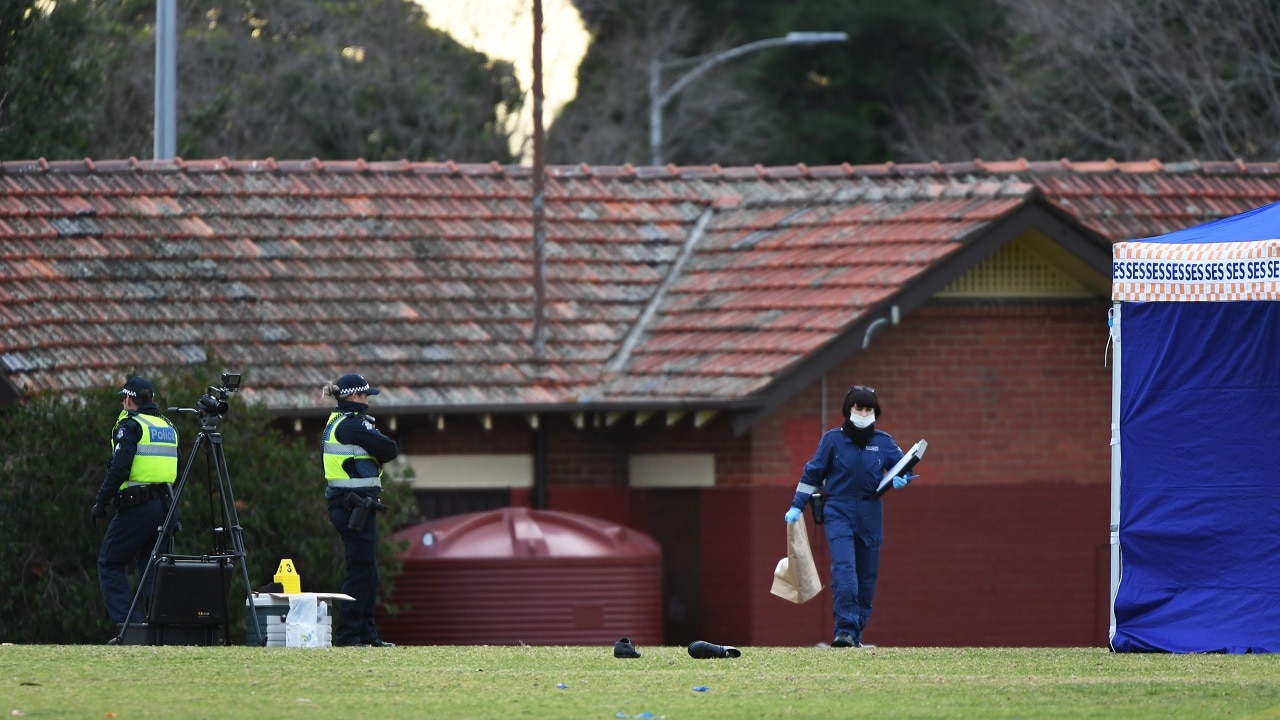 Victorian Police Forensic Officers are seen at the scene where a woman's body was found in Melbourne.