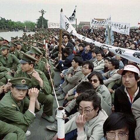 Several hundred of 200,000 pro-democracy student protesters face to face with policemen outside the Great Hall of the People in Tiananmen Square 22 April 1989