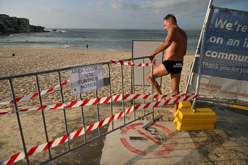 Beachgoers ignore barriers at Bondi beach. 