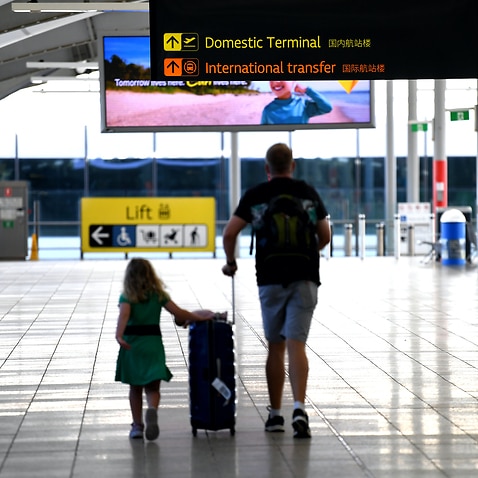 Departing passengers make their way to the domestic terminal in Brisbane airport in December 2020.