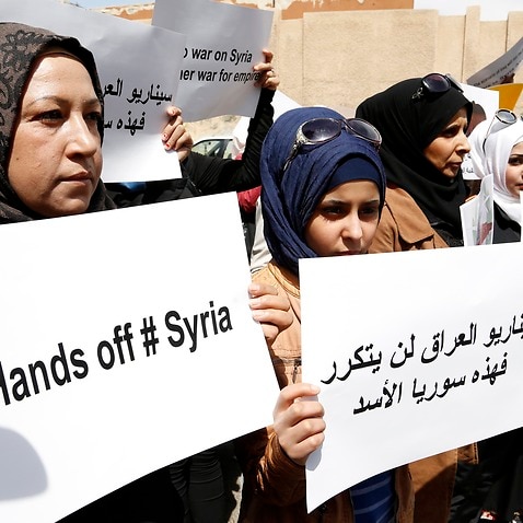 Dozens of Syrians gathered outside the offices of the United States in Damascus, Syria