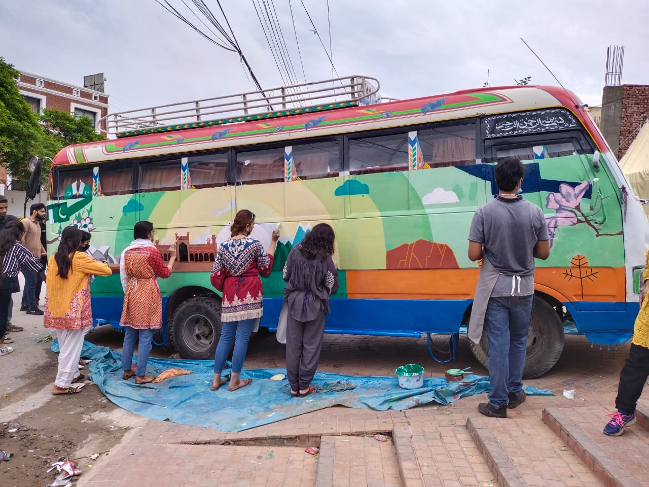 Public buses showcasing artworks with Australian and Pakistani images, by Pakistani-Australian artists.
