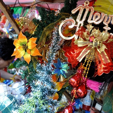 Customers buy Christmas decor along the streets of Manila