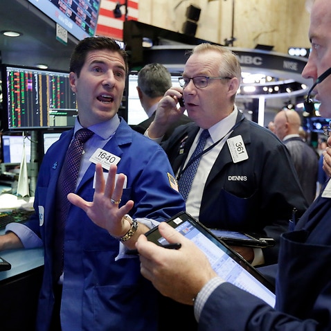 Specialist Thomas McArdle, left, works on the floor of the New York Stock Exchange, Wednesday, Nov. 2, 2016. Stocks are opening modestly lower on Wall Street as the market extends a pre-election losing streak. (AP Photo/Richard Drew)