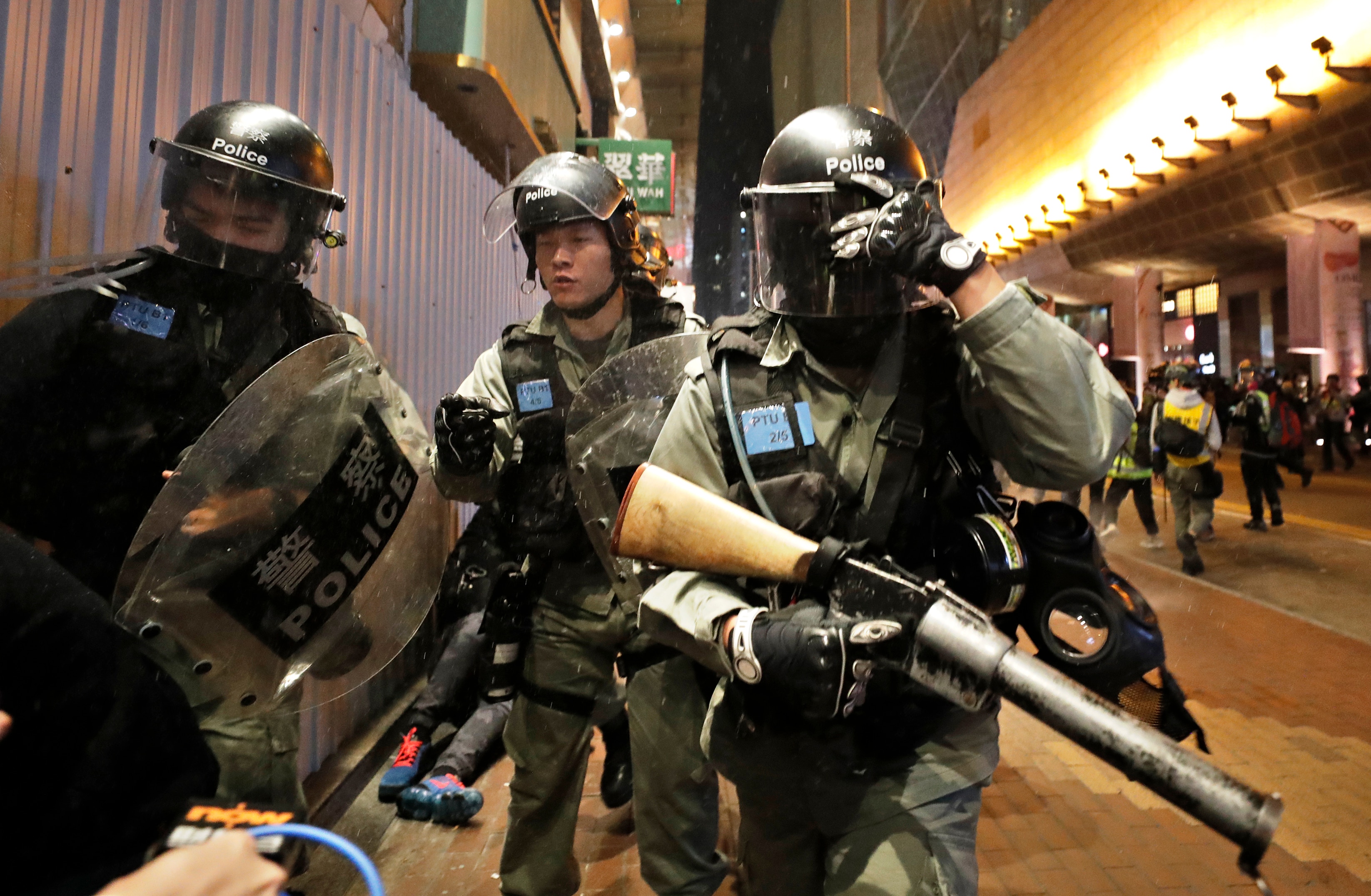 Riot police walk to detain protesters during a demonstration in Hong Kong.