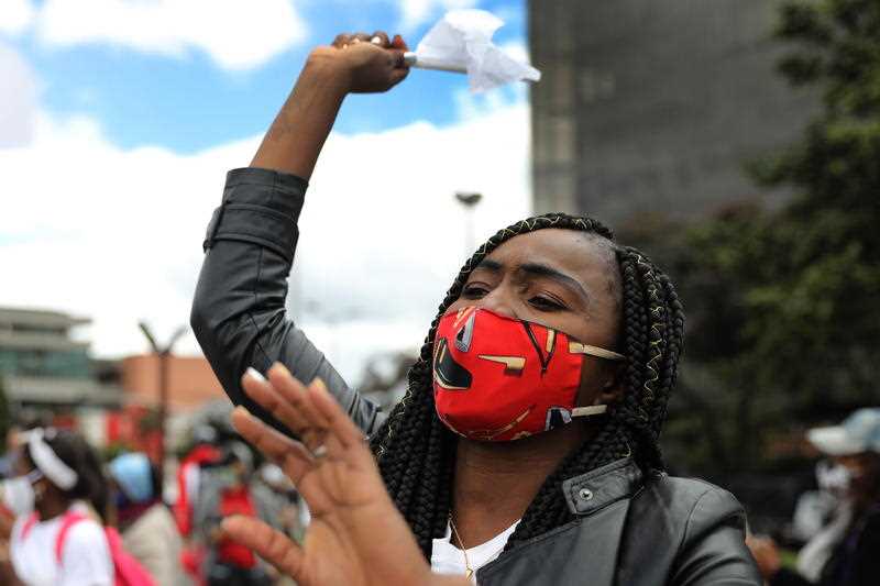 A young woman shouts protest slogans during a demonstration against the massacres, in Bogota, Colombia.