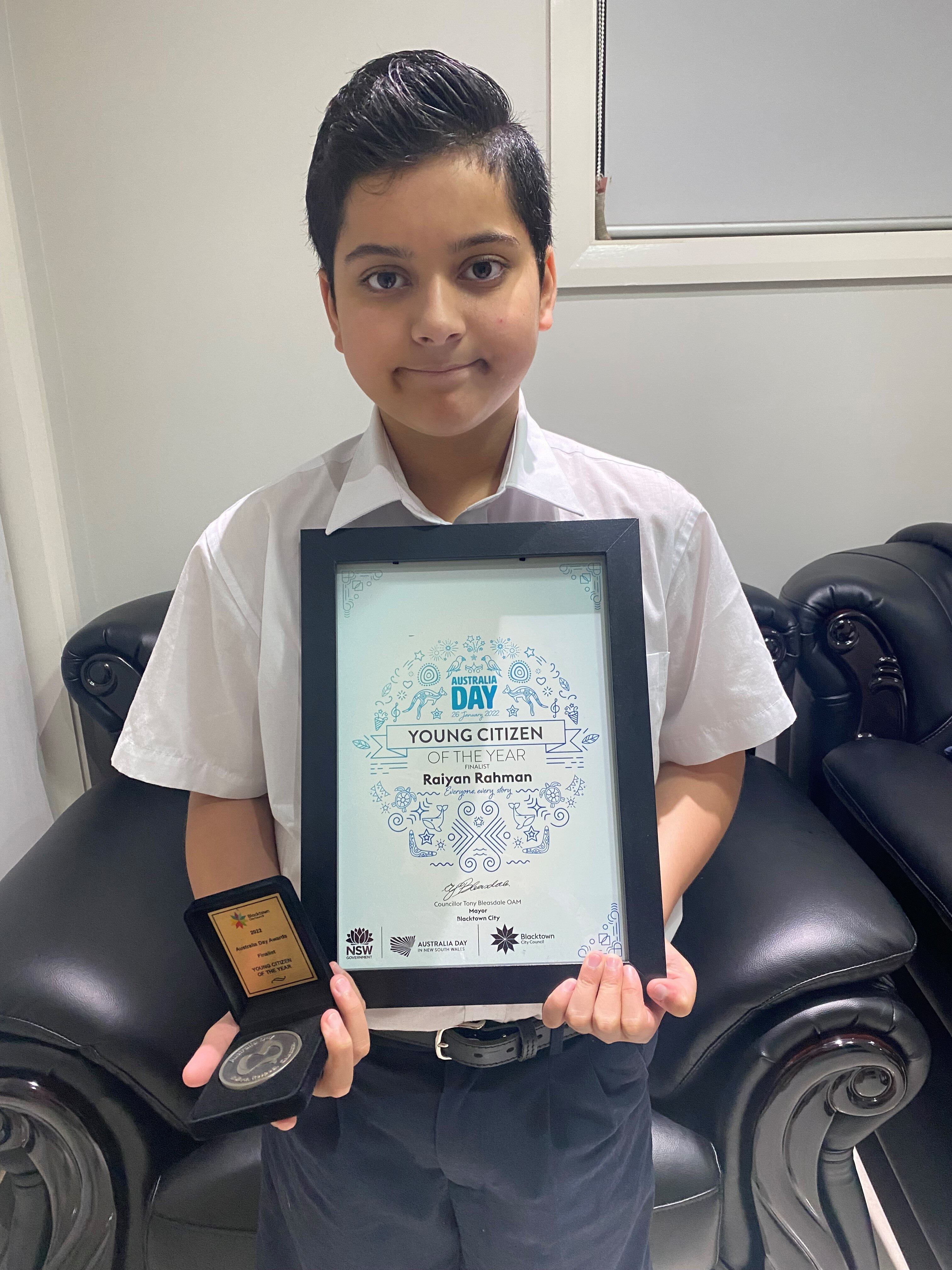 Year 7 student Raiyan is holiding his Blacktown City's young citizen finalist award. 