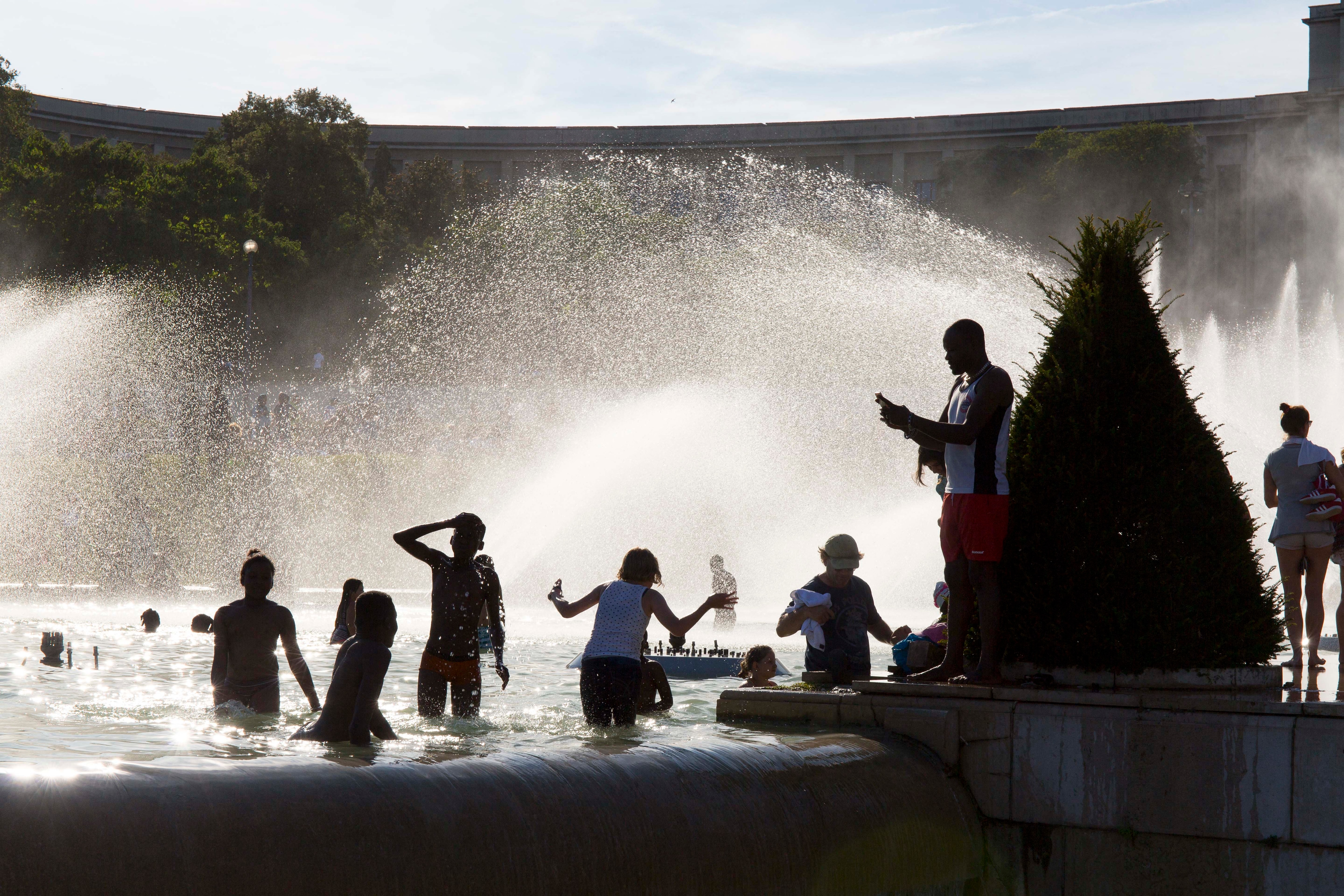 People cool off in ponds at the Trocadero in Paris, France, June 23, 2019.