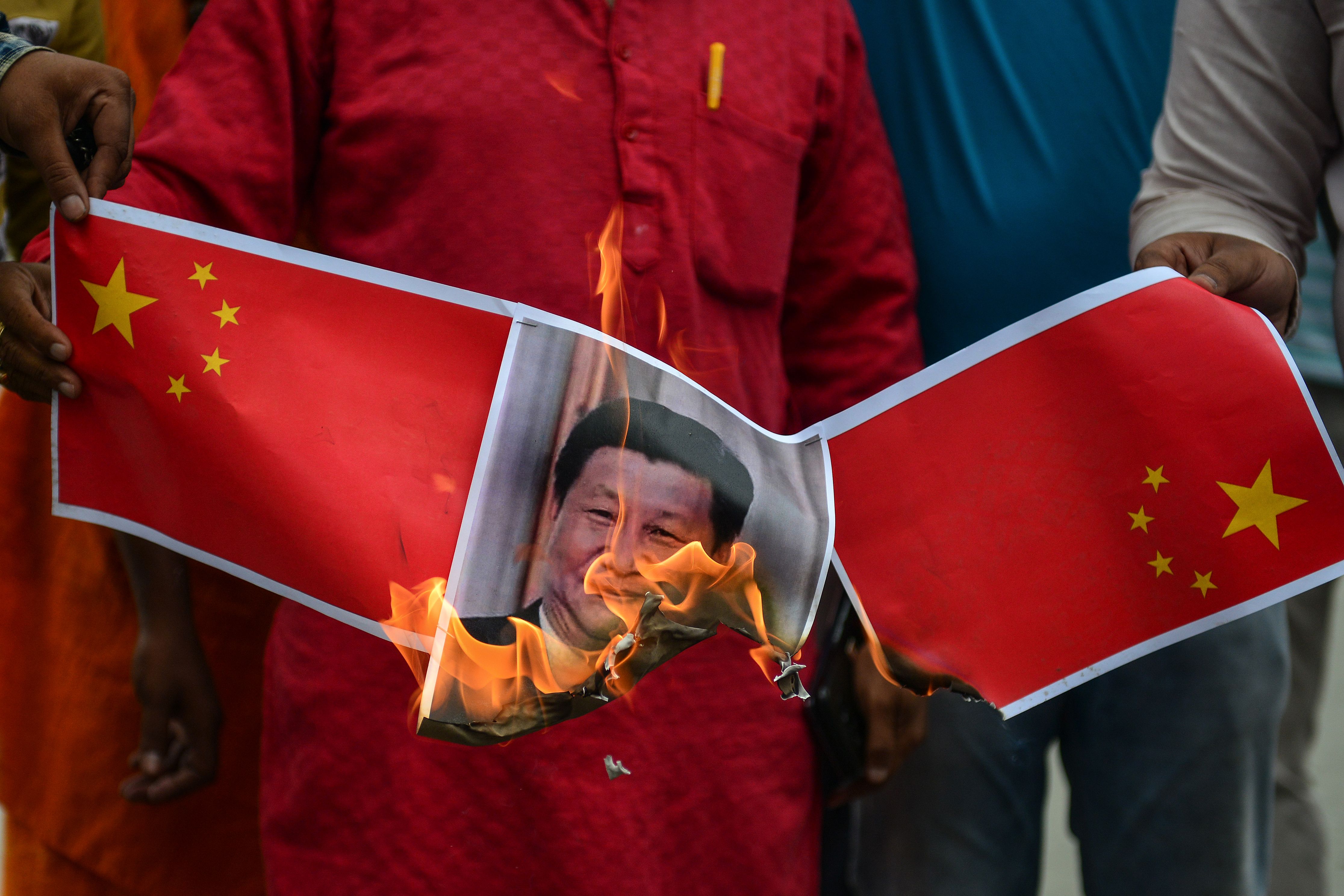 Bharatiya Janata Party (BJP) supporters burn posters and effigy of Chinese President Xi Jinping during an anti-China protest in India, June 2020. Bharatiya Janata Party (BJP) supporters burn posters and effigy of Chinese President Xi Jinping during an anti-China protest in India, June 2020.