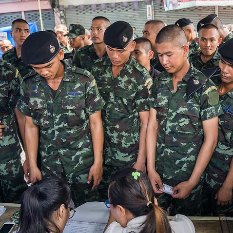 Members of the Thai military registering at a polling station before casting their ballots. 