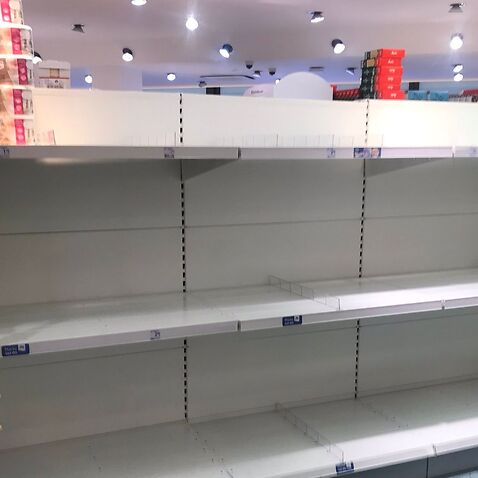 Supermarket shelves empty of toilet paper