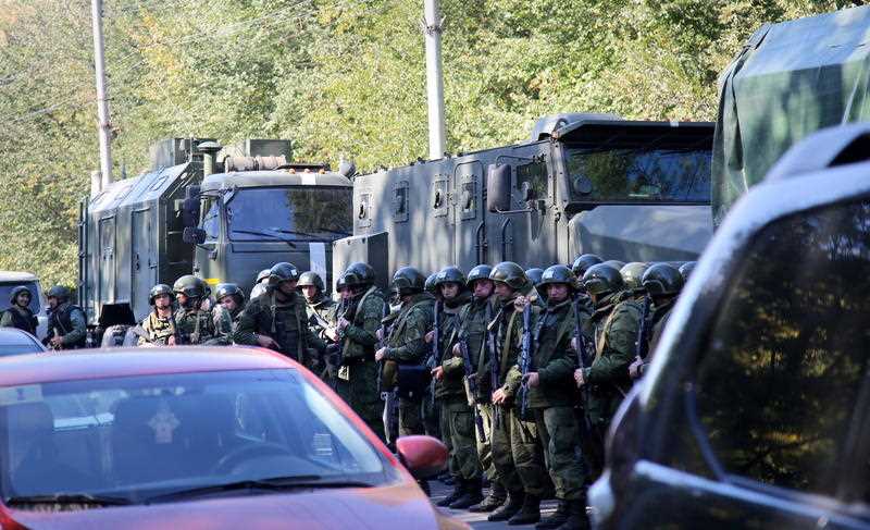 Military forces block the road to the site of attack at a vocational school in Kerch in Crimea.