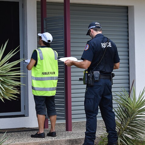 A Public Health environmental health officer, NT Police officer and an Australian Defence Force member check in on those self isolating to ensure they are following quarantine regulations
