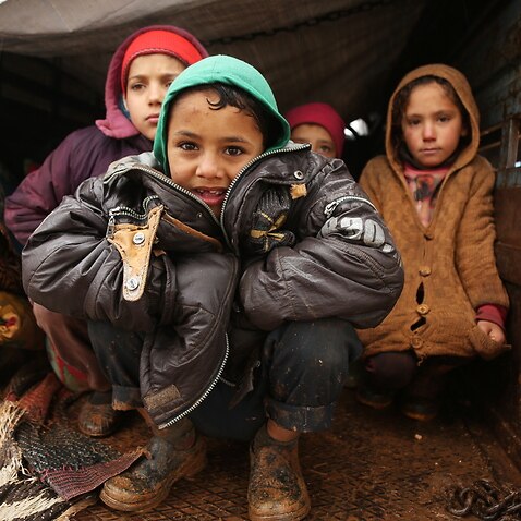 Displaced, refugee Syrian children live in a truck after fleeing violence near the Turkish border