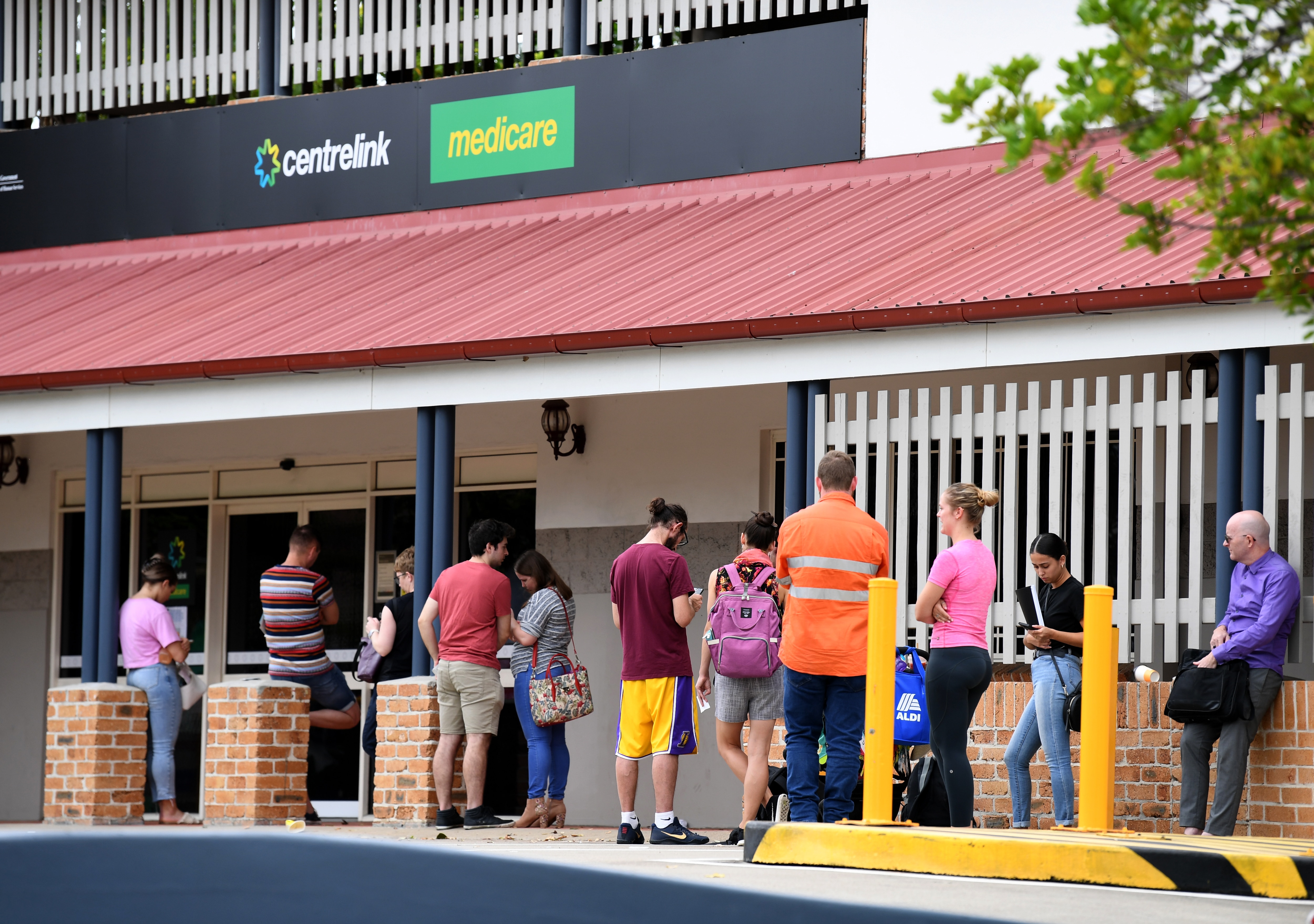 A long queue outside a Centrelink office in Brisbane at the peak of the COVID-19 crisis in March last year. 