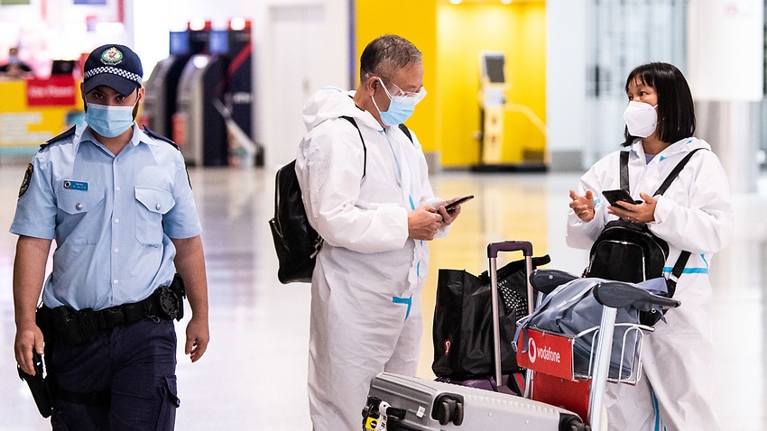 People wearing PPE arriving at Sydney International Airport in Sydney, Monday, 29 November, 2021.