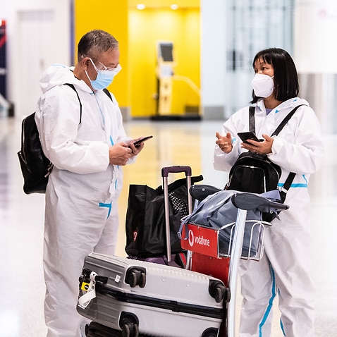 People wearing PPE arriving at Sydney International Airport in Sydney, Monday, 29 November, 2021. 