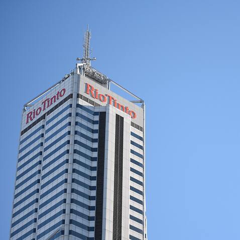 Rio Tinto logo at the top of a high-rise building. Shares in Rio Tinto fell after Serbia revoked its lithium exploration licenses over environmental concerns.