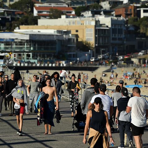 people flock to Bondi Beach to enjoy sunshine.