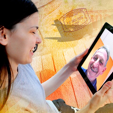 Stock photo of a woman on a video call with her father