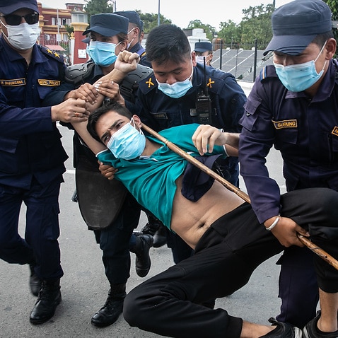 Police personnel arrest protesters affiliated with the main opposition Nepali Congress party who are against the dissolution of parliament for the second time.