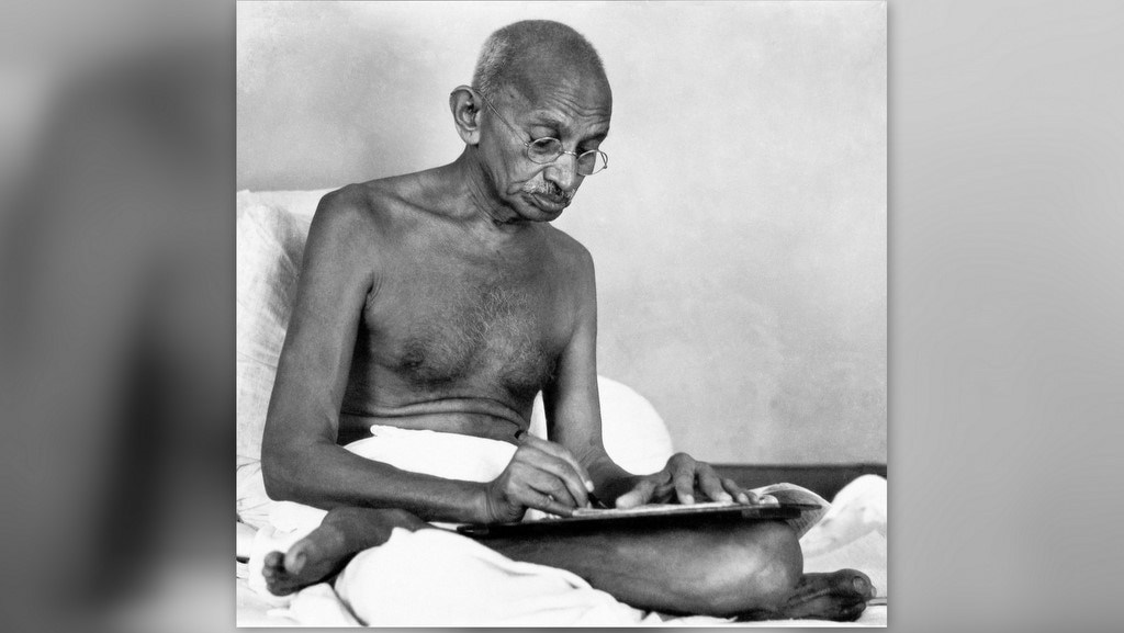 Mohandas Karamchand Gandhi (1869 - 1948) writing at Birla House, Mumbai, August 1942. (Photo by Dinodia Photos/Getty Images)