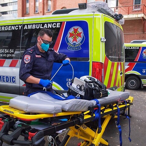 A paramedic moves equipment outside St. Vincent's Hospital in Melbourne as a Code Brown is declared 