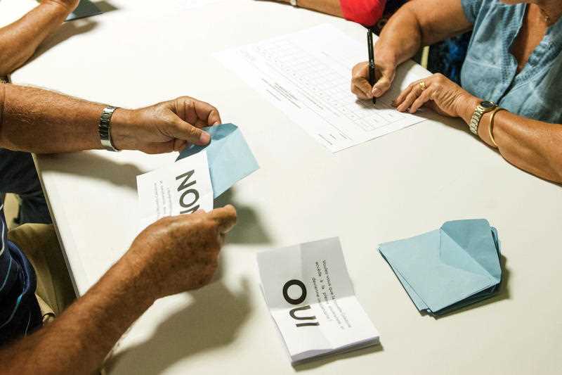 Polling station officials count the votes as part of the independence referendum in Noumea, the New Caledonia's capital, Sunday, Nov. 4, 2018