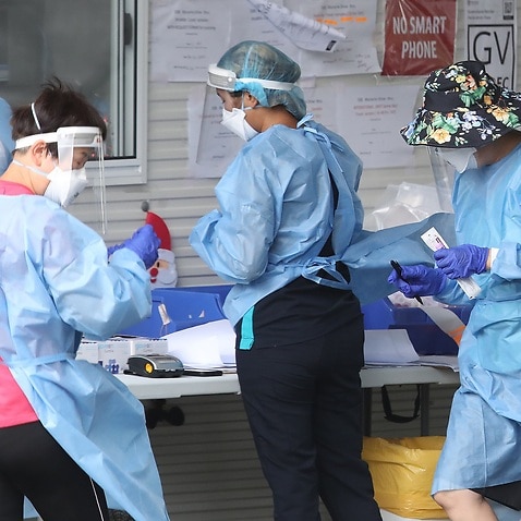 Health workers at a COVID-19 testing site in Brisbane on 7 January 2022.