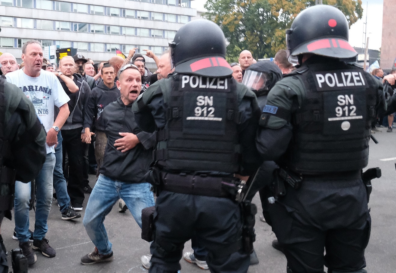 Police officers try to prevent a clash between right and left groups during a rally of the right-wing after the violent death of a 35-year-old man