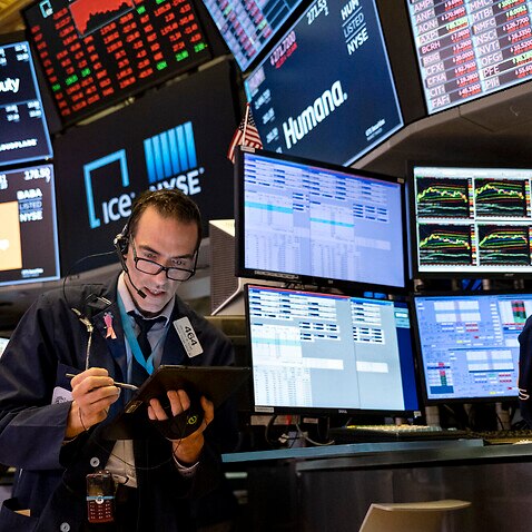Trader Trader Gregory Rowe works on the floor of the New York Stock Exchange at the end of the trading day Monday, March 16, 2020. (AP Photo/Craig Ruttle)