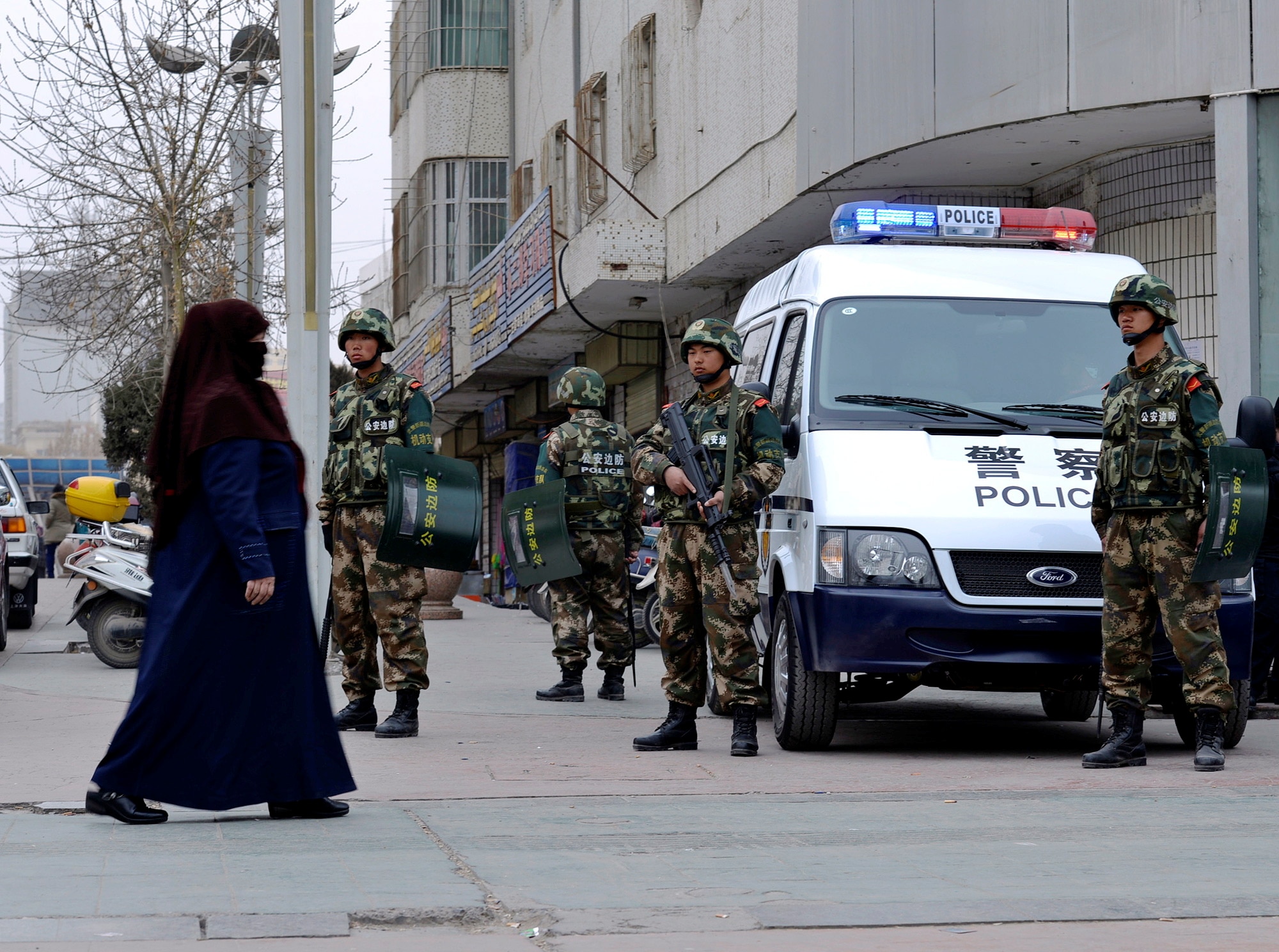 Chinese paramilitary policemen stand guard on a street in Kashgar, Xinjiang, in 2014. Chinese paramilitary policemen stand guard