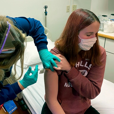 Katelyn Evans, a participant in a clinical trial of Pfizer's COVID-19 vaccine, gets her shot at Cincinnati Children’s Hospital Medical Center in October, 2020.