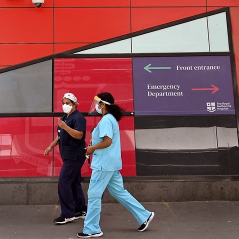 Medical staff walk past the emergency entrance at the Royal Melbourne Hospital in Melbourne.