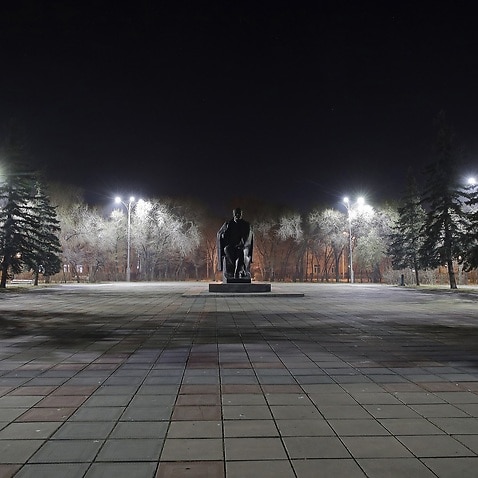 A statue of Vladimir Lenin in an empty square as paid non-working days are introduced in Russia