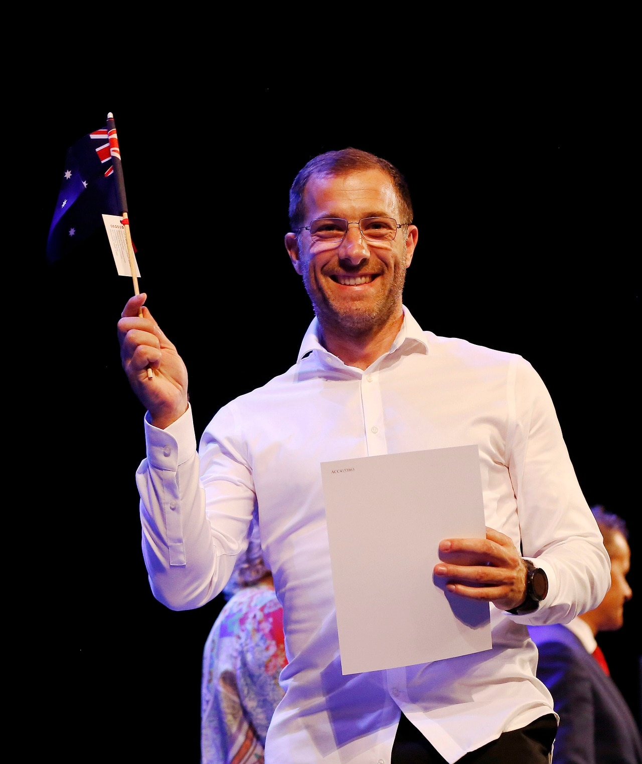 New Australian Sylvain Della Libera waves his the Australian flag at a citizenship ceremony. New Australian Sylvain Della Libera waves his the Australian flag at a citizenship ceremony.