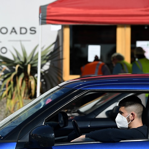 A man waits at the Crossroads Hotel testing centre in Sydney, Monday, July 13, 2020. (AAP Image/Joel Carrett) NO ARCHIVING