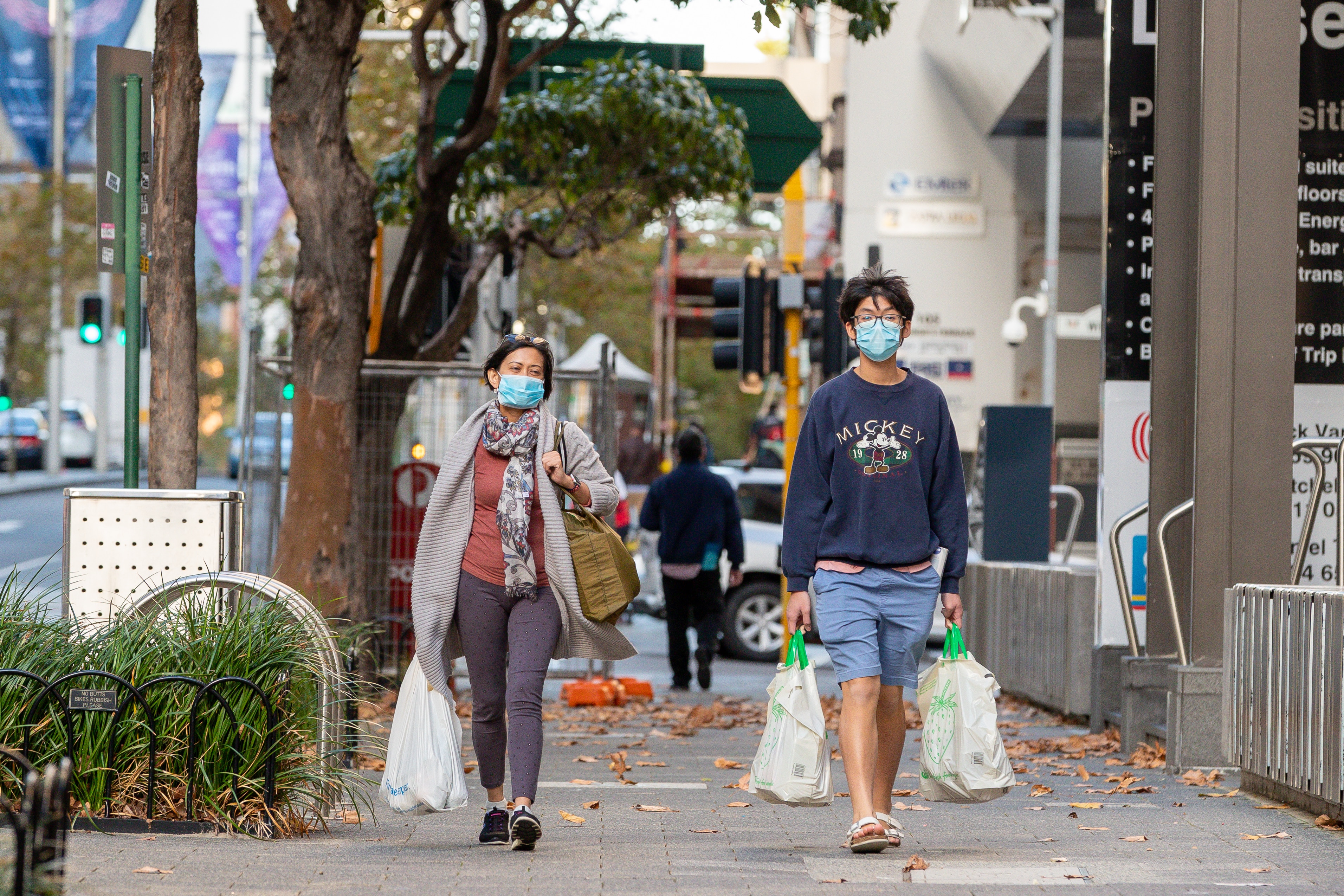 Masked members of the public are seen on St Georges Terrace in Perth.