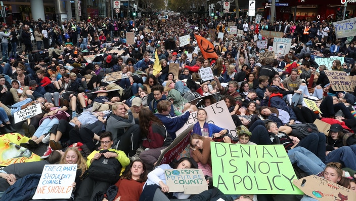Protesters are seen lying down on Swanston Street during a 'Climate Rally' in solidarity with the Global Climate Strike in Melbourne.