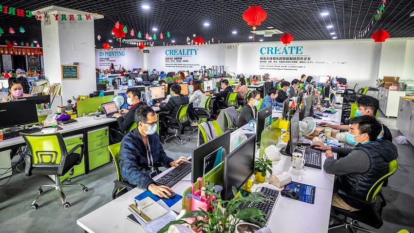 Staff wearing protective masks work in an office at Creality 3D in Shenzhen, Guangdong province, China.